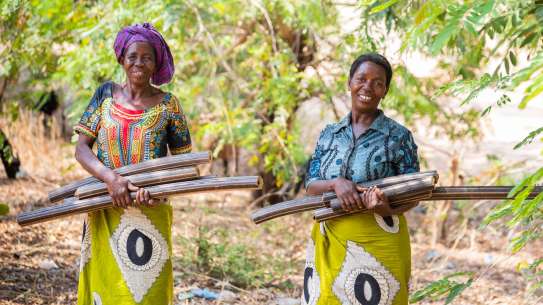 Olive Ngwira with fellow member of the Hara women’s briquette group Lucy Kadundu with their rice husk briquettes.