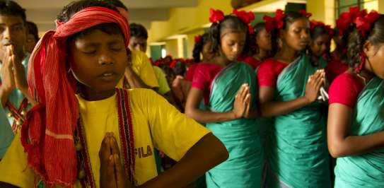Children praying, India