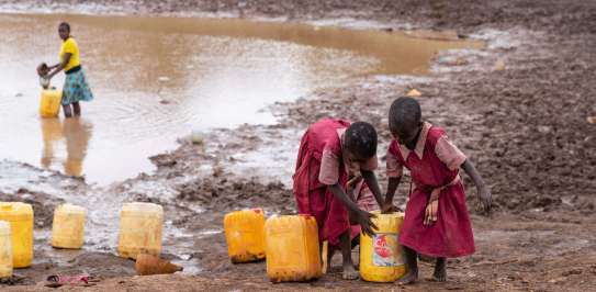 Children collecting water in buckets in Kitui, Kenya
