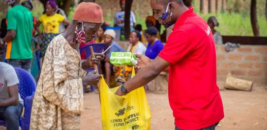 Tyonyar Ungon, 60, collecting his hygiene kit at an aid distribution funded by Christian Aid’s Covid appeal in Adagi community, Benue State, Nigeria, November 2020. He is partially disabled.