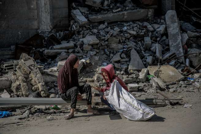 Children in front of destroyed building