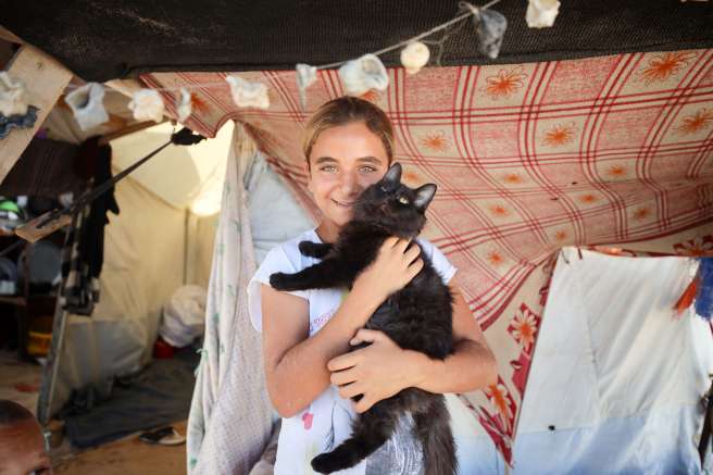 Girl holds pet cat 