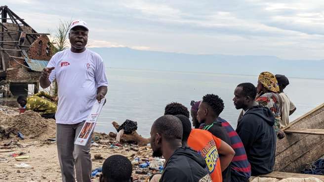 Health worker speaking to group of people