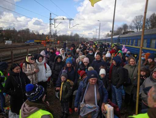 Ukrainians arrive at a Polish train station