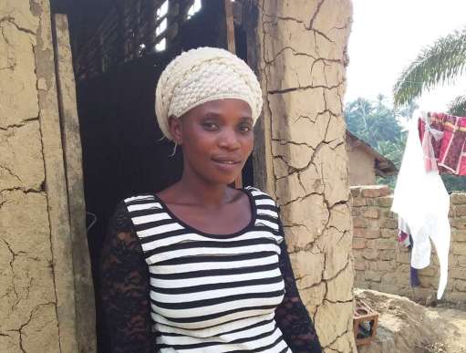 Fatuma Amuli stands outside her relative’s home in South Kivu Province, Eastern Democratic Republic of Congo