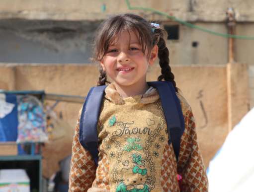 Sara standing in a camp in Aleppo