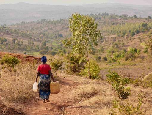 Woman walks for water in Burundi